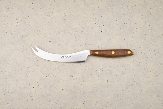 Arcos Nordika 125mm Manchego Knife features a curved blade with a two-pronged tip, perfect for slicing cheese. Its wooden handle and three-rivet construction showcase craftsmanship from Albacete, Spain.