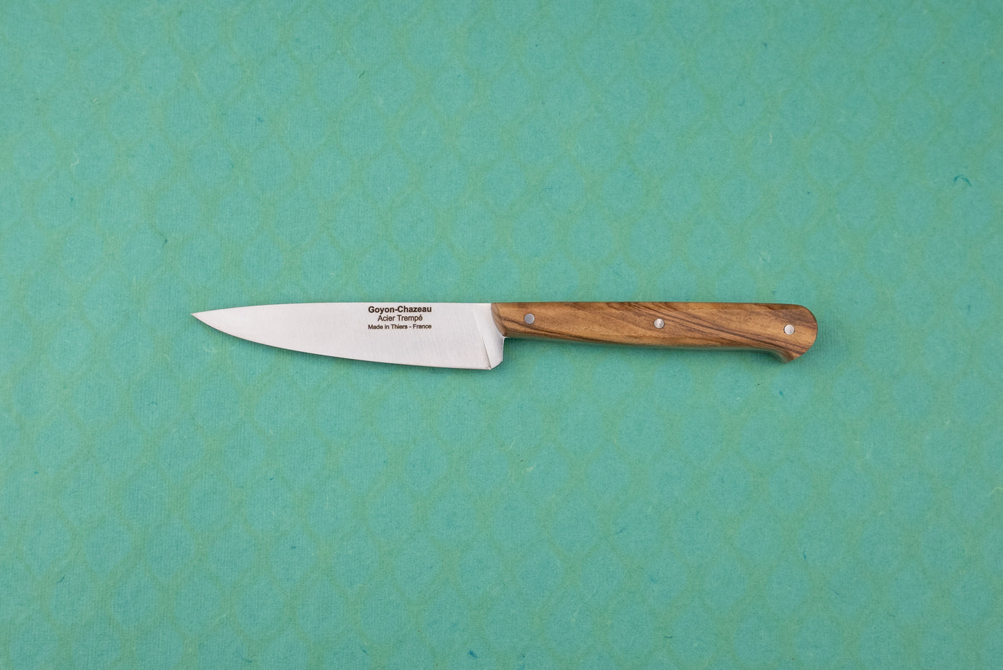 Goyon-Chazeau Le P'tit Tradi: A slim utility paring knife with a wooden handle and stamped stainless steel blade, ideal for precise kitchen tasks like slicing shallots and herbs.