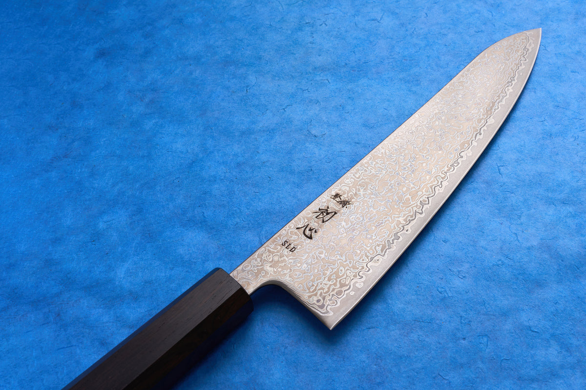 Hatsukokoro SLD Hikari Kurozome Damascus Gyuto 210mm, featuring a Damascus-patterned blade with Japanese kanji, and a dark wood octagonal handle, ideal for versatile kitchen use.