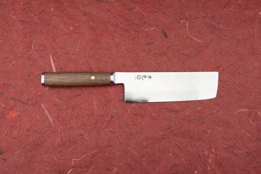 Hazaki Pro Series Nakiri 165mm features a straight, rectangular blade with Japanese engravings and a hammered pattern, paired with a dark wood handle and decorative brass mosaic pin.