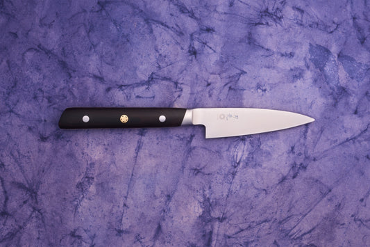 Hazaki Classic Black Petty 90mm: A sleek, stainless-steel blade with Japanese characters, paired with a dark, riveted handle, embodies refined craftsmanship, perfect for precise kitchen tasks.