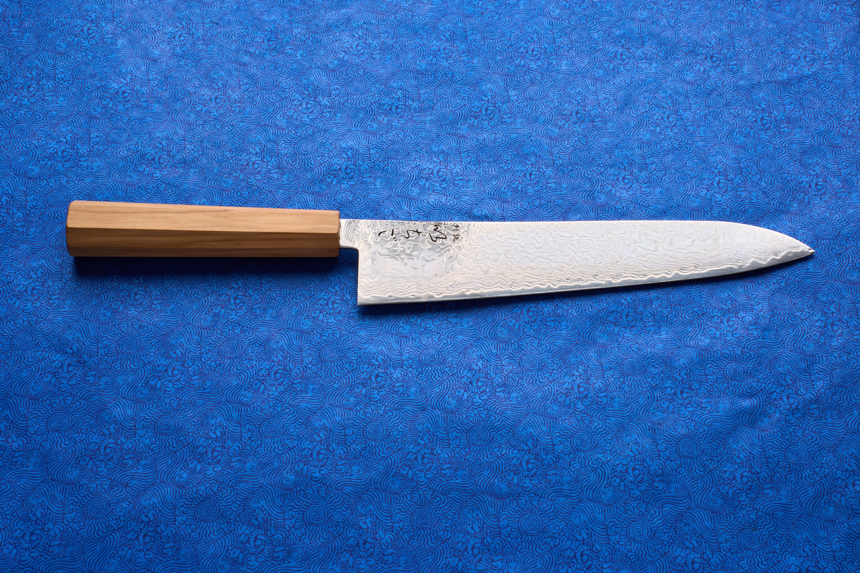 ICHIGO Haku Gyuto 240mm, a Japanese chef's knife, features a high-carbon Damascus-patterned blade and a light wooden octagonal handle, ideal for versatile kitchen tasks like slicing and dicing.