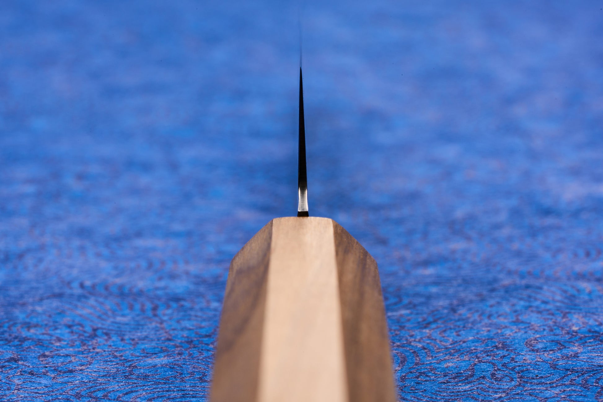 Close-up of the ICHIGO Haku Petty 150mm knife, showcasing its slender, high-performance blade and light wooden 'wa' handle, ideal for precision tasks on a cutting board.