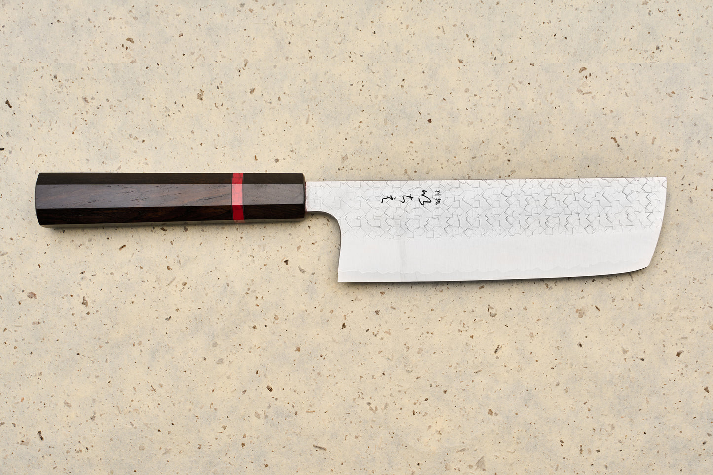 ICHIE x Shibata Knives SG2 Tsuchime Nakiri 165mm features a straight, rectangular Damascus blade with Japanese characters, complemented by an octagonal dark wood handle with a red accent ring, ideal for precise vegetable chopping.