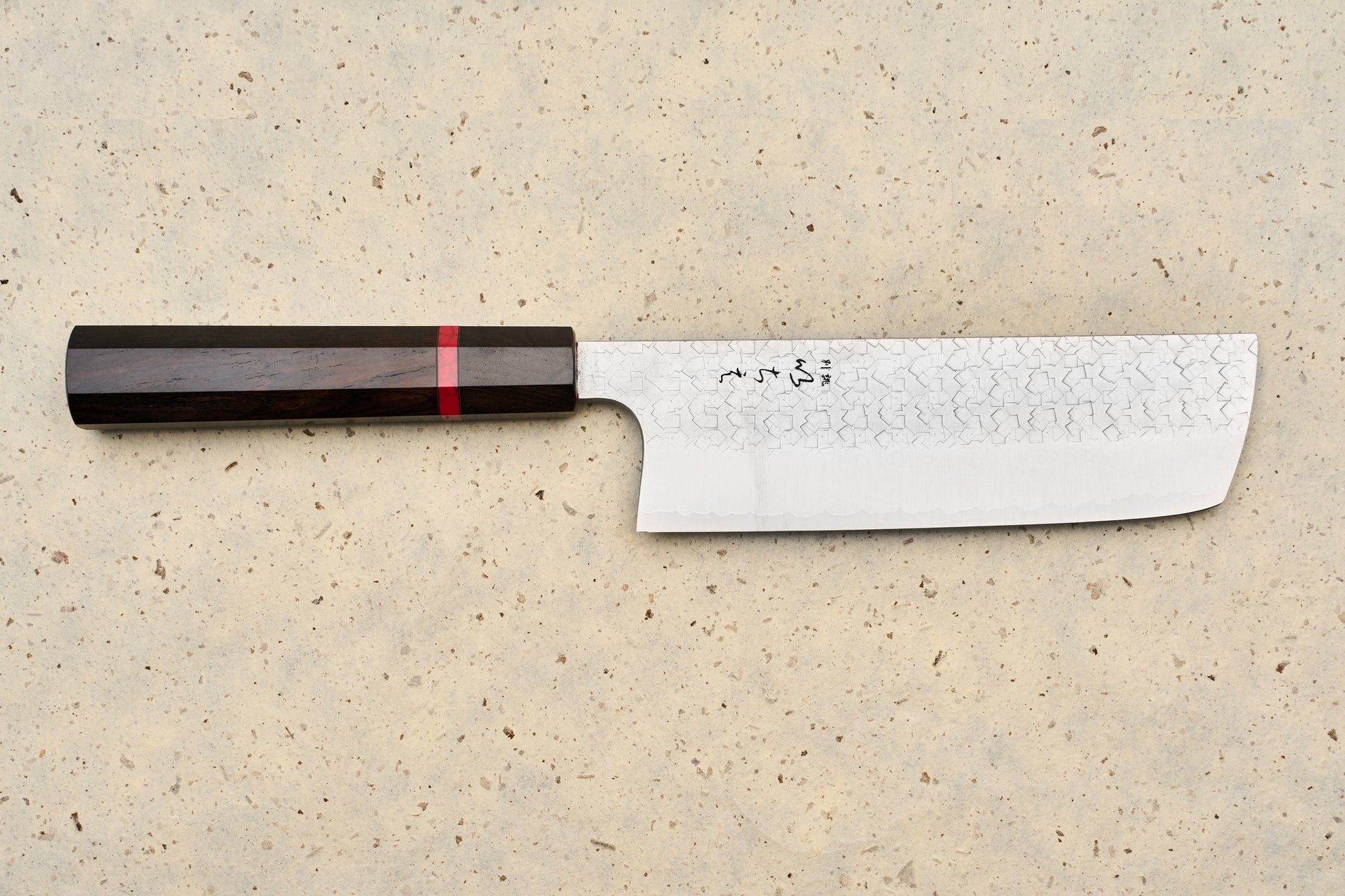 ICHIE x Shibata Knives SG2 Tsuchime Nakiri 165mm features a straight, rectangular Damascus blade with Japanese characters, complemented by an octagonal dark wood handle with a red accent ring, ideal for precise vegetable chopping.