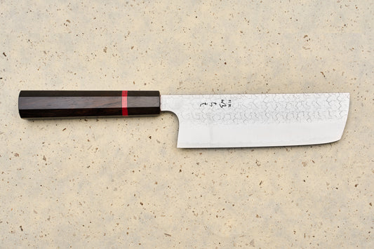 ICHIE x Shibata Knives SG2 Tsuchime Nakiri 165mm features a straight, rectangular Damascus blade with Japanese characters, complemented by an octagonal dark wood handle with a red accent ring, ideal for precise vegetable chopping.