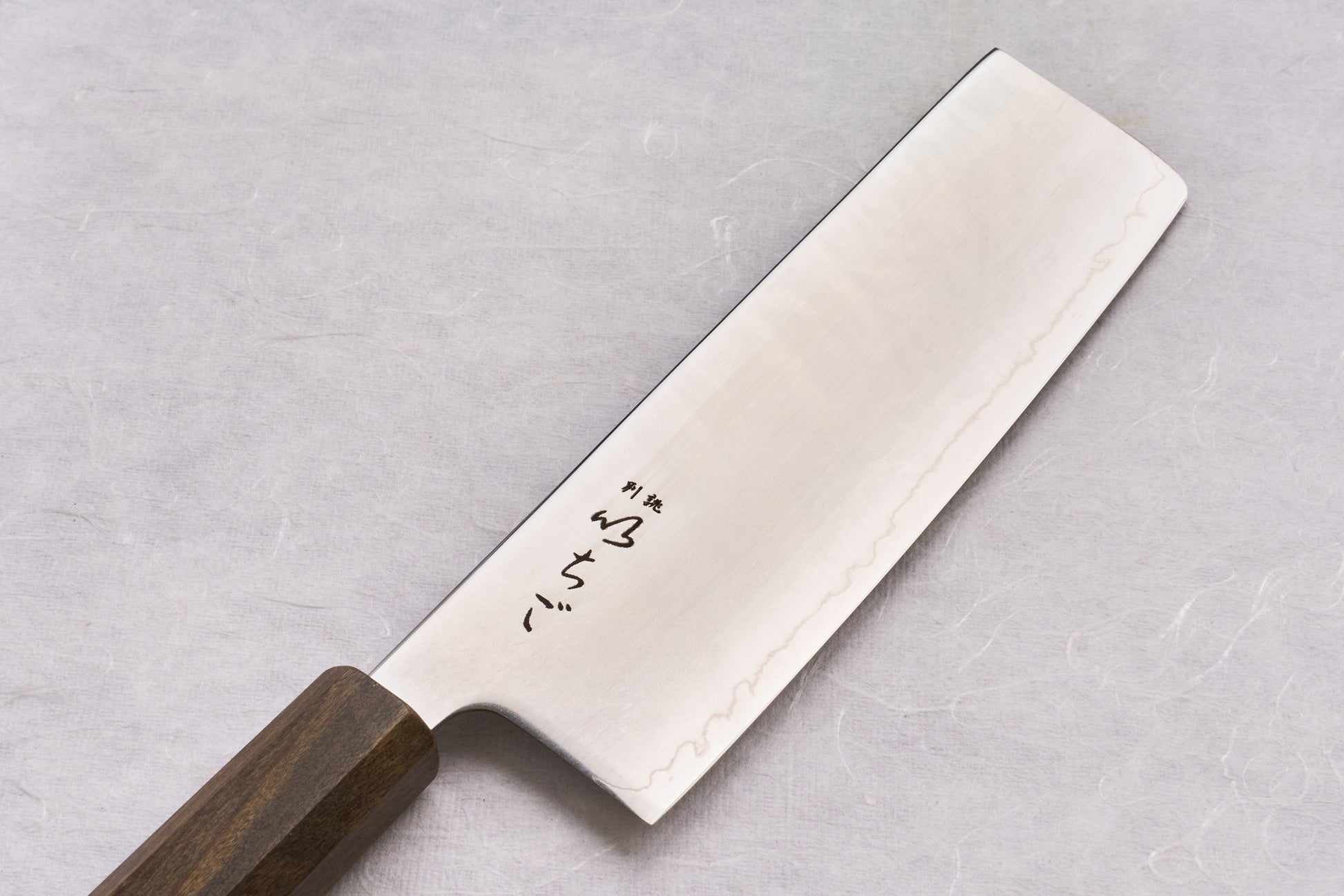 ICHIGO SLD Migaki Nakiri 160mm features a polished stainless blade with Japanese engravings and an octagonal dark wood handle, ideal for precise vegetable chopping.