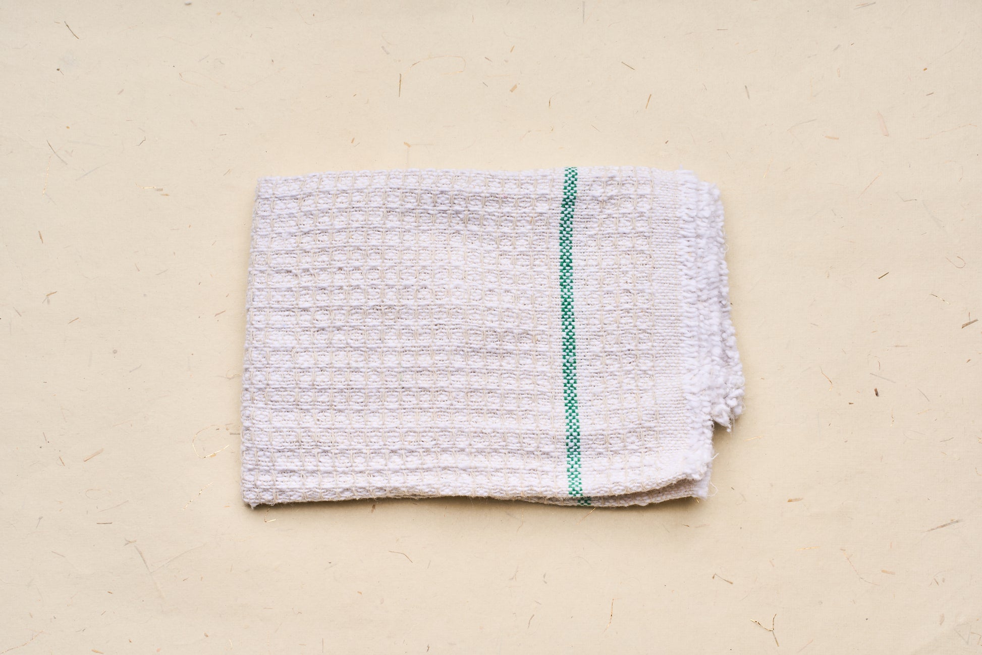 Iris Hantverk Cleaning Cloth, featuring a waffle-weave texture and green stripe, made from 100% recycled cotton, ideal for kitchen or cleaning tasks.