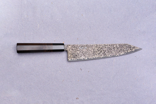 Kanjo SG2 Nickel Damascus Kiritsuke Gyuto 240mm with a dark wooden octagonal handle and intricate Damascus-steel blade, ideal for versatile culinary use.