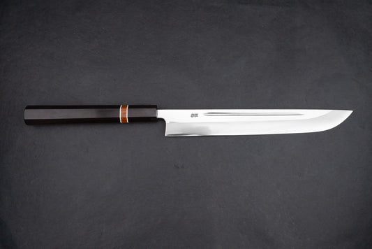 Kurotori Tanzo Ginsan Maguro Bocho, a sleek Japanese slicing knife, features a polished steel blade for precision cuts and a dark octagonal wooden handle, ideal for sashimi preparation.