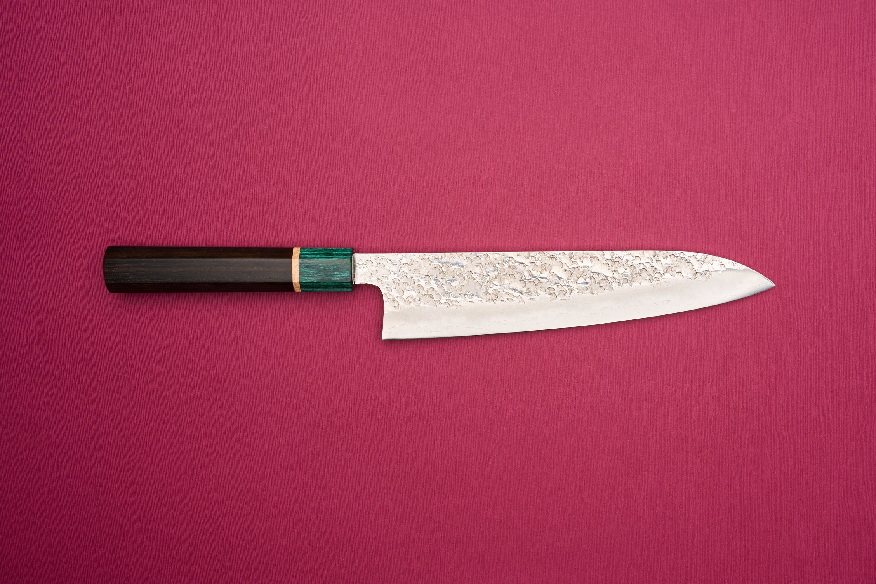 Makoto Kurosaki SPG STRIX Samidorizuki Gyuto 210mm features a hammered blade and octagonal wooden handle, embodying Japanese craftsmanship. Ideal for versatile kitchen use, inspired by European chef knife design.