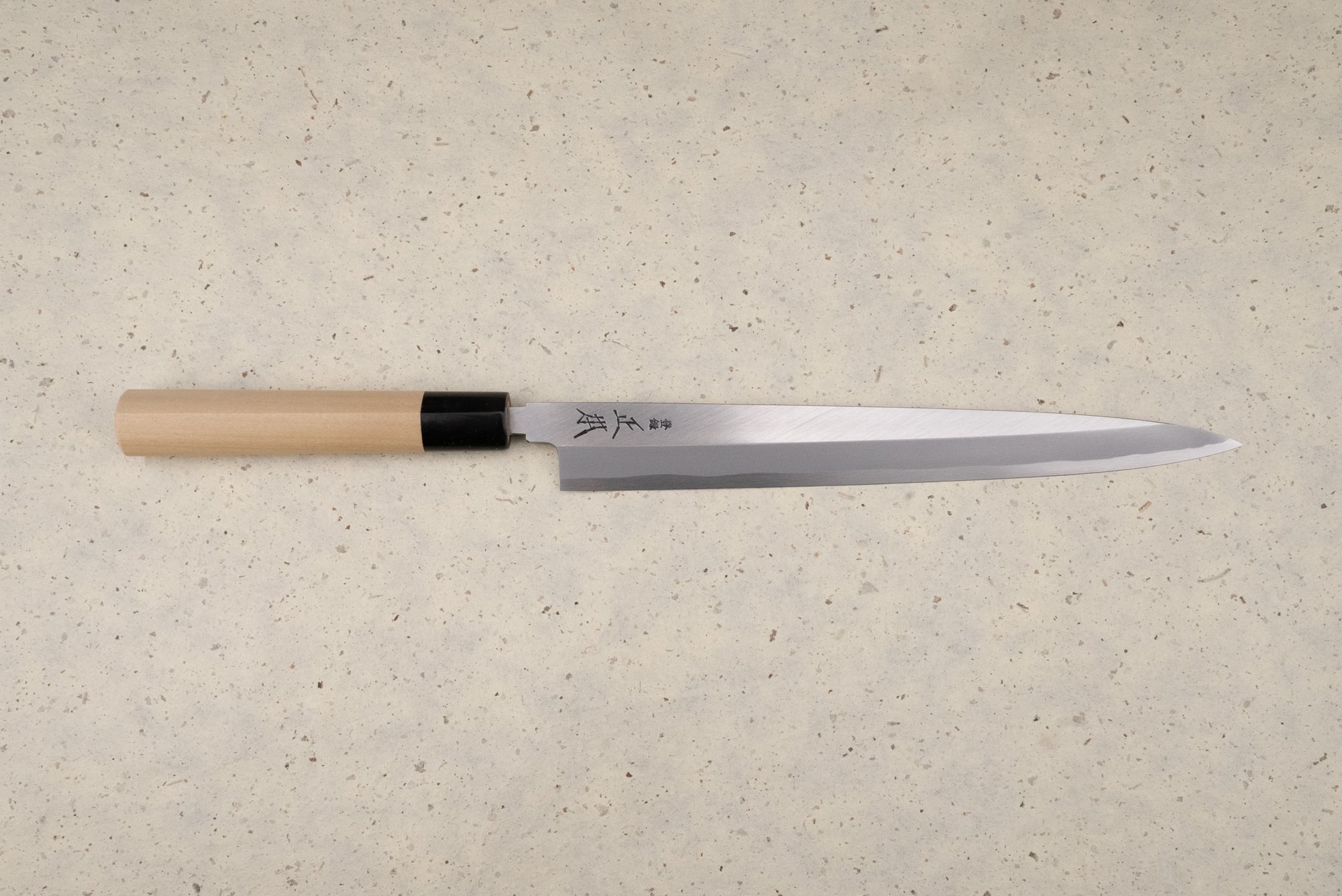 Masamoto KK Shirogami Kasumi Yanagiba 270mm, a traditional Japanese sashimi knife, features a long single-bevel steel blade with kanji and a straight wooden handle, ideal for precise fish slicing.