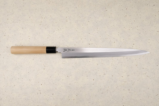 Masamoto KK Shirogami Kasumi Yanagiba 300mm knife with a single-bevel blade and Japanese characters, featuring an octagonal wooden handle with a black ferrule, perfect for slicing sashimi elegantly.