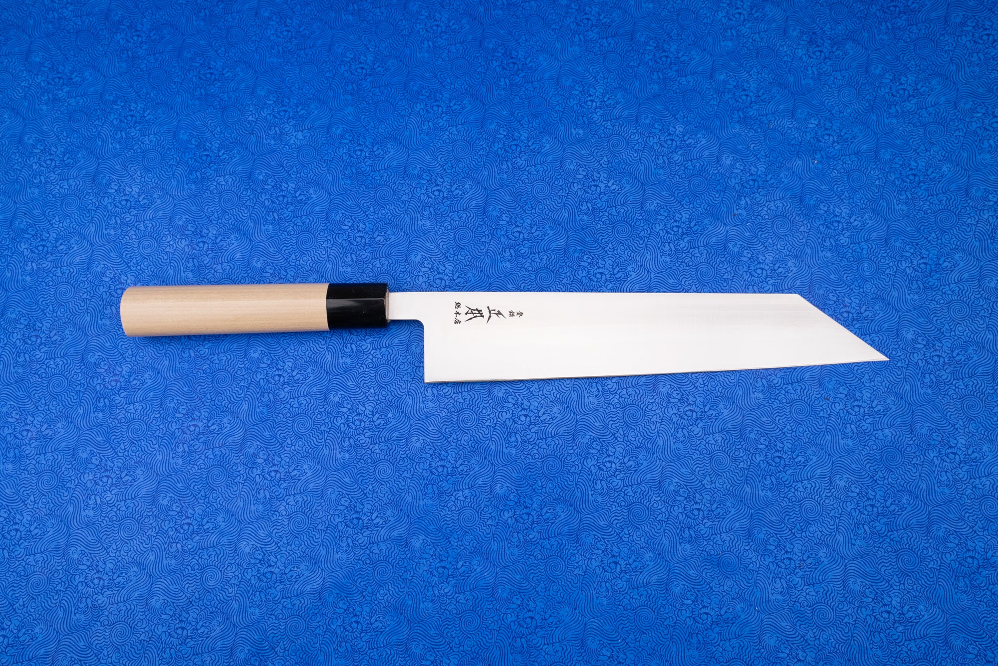 Masamoto MV Kiritsuke Gyuto 240mm, a Japanese-style kitchen knife with a long, straight-edged blade and sharp, angled tip, featuring a simple turned-wood handle, perfect for precise slicing and carving.
