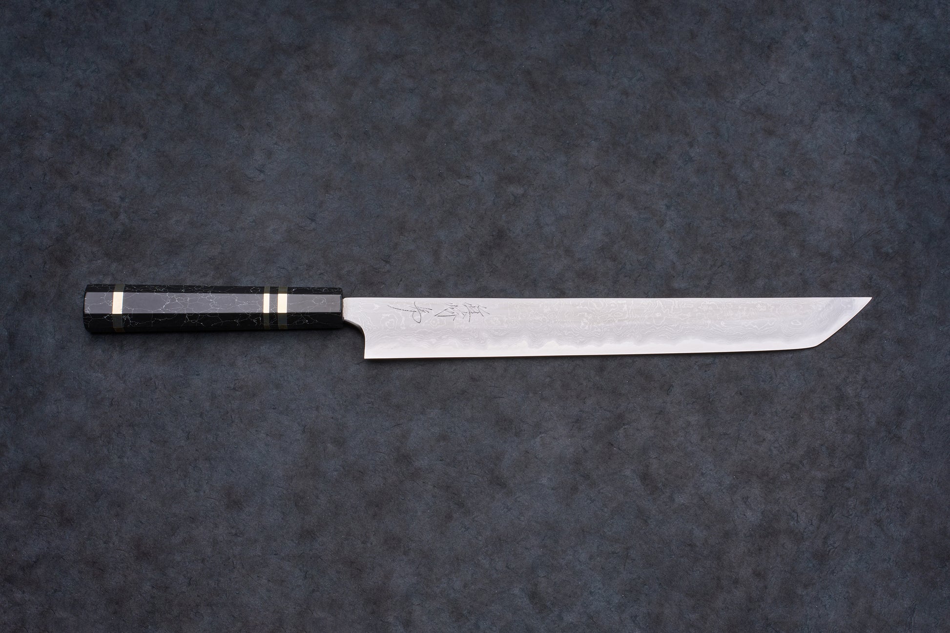 Mazaki Aogami Super Honsanmai Damascus Sakimaru Sujihiki 300mm, featuring a long, Damascus-patterned blade with hand-engraved signature and dark octagonal handle with brass ferrule.