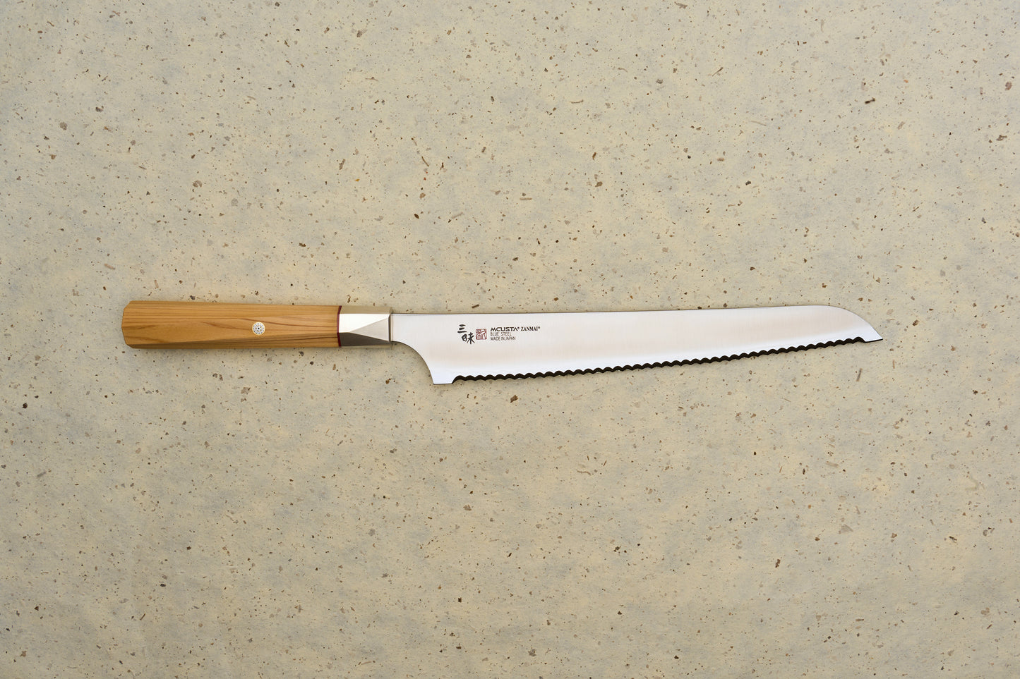 Mcusta Zanmai Beyond Bread Knife 230mm, featuring a serrated blade with MCUSTA ZANMAI – Made in Japan stamp, octagonal Hinoki wood handle; ideal for precise bread slicing.