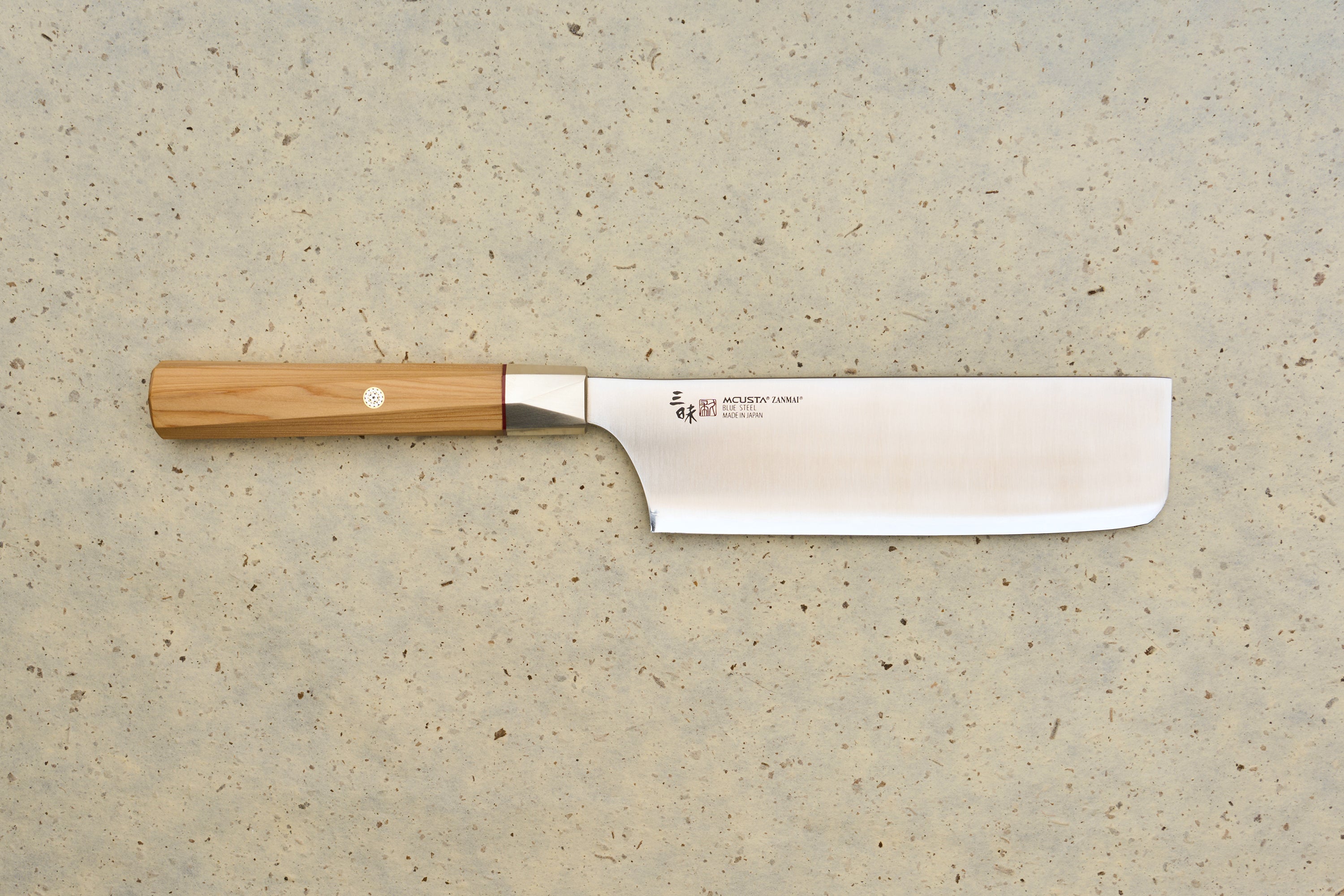 Mcusta Zanmai Beyond Nakiri 165mm knife with a straight, rectangular blade marked Blue Steel Made in Japan and an octagonal wooden handle, reflecting Mcusta's precision craft in Japanese kitchen tools.