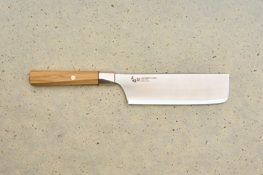 Mcusta Zanmai Beyond Nakiri 165mm knife with a straight, rectangular blade marked Blue Steel Made in Japan and an octagonal wooden handle, reflecting Mcusta's precision craft in Japanese kitchen tools.