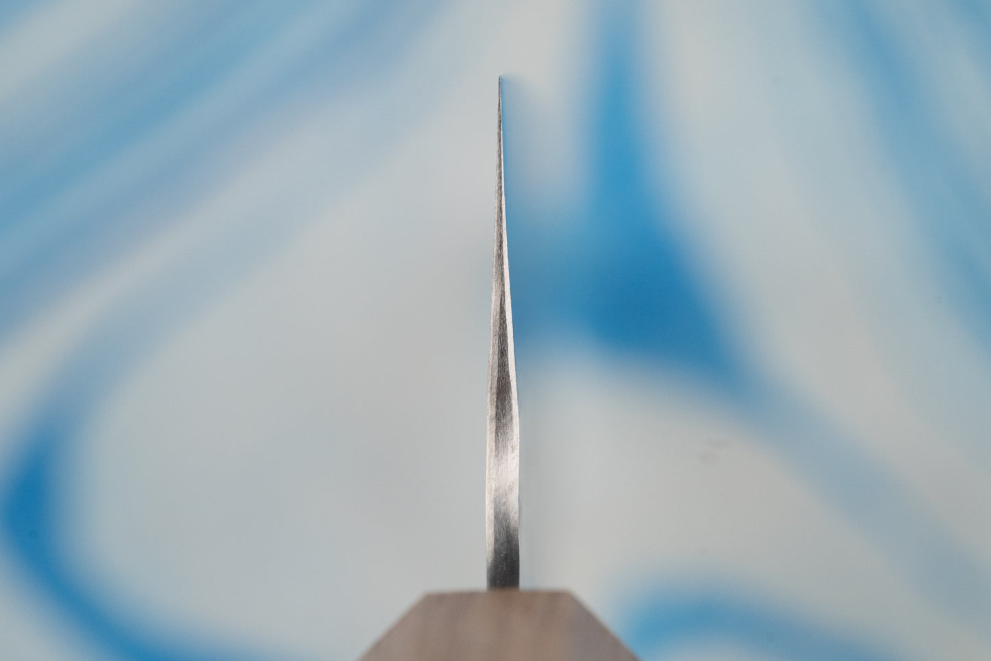 Close-up of the Nigara SPG STRIX Tsuchime Damascus Gyuto 210mm, showcasing its precise, wedge-shaped blade edge, embodying centuries-old craftsmanship and modern knifemaking expertise from Nigara Hamono.