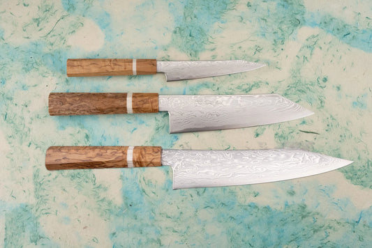 Ryusen Fukakuryu KAI 3 Piece Knife Set featuring hand-forged Damascus steel blades and octagonal wooden handles, showcasing a gyuto, santoku, and larger chef’s knife, perfect for precision cutting.