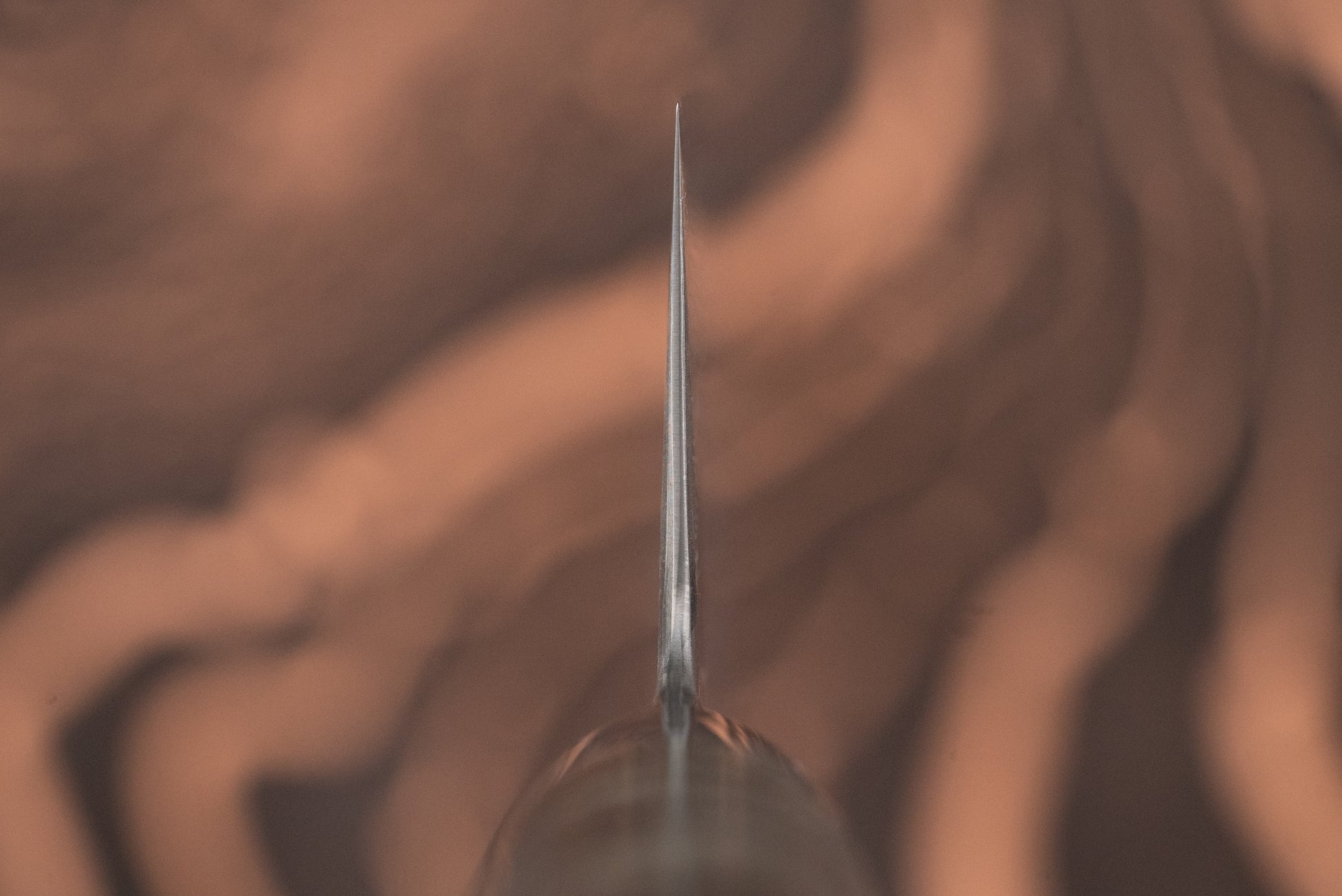 Close-up of the Ryusen Oukokuryu Sujihiki 260mm's sharp blade tip, showcasing its precision edge designed for effortless slicing, embodying high-end Japanese craftsmanship with superior edge-retention and sleek modern design.