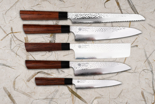 Seki Kanetsugu Heptagon-wood 5 Piece Knife Set with hammered blades and dark-wood octagonal handles, including bread, gyuto, nakiri, santoku, and petty knives, showcasing Japanese craftsmanship and precision.