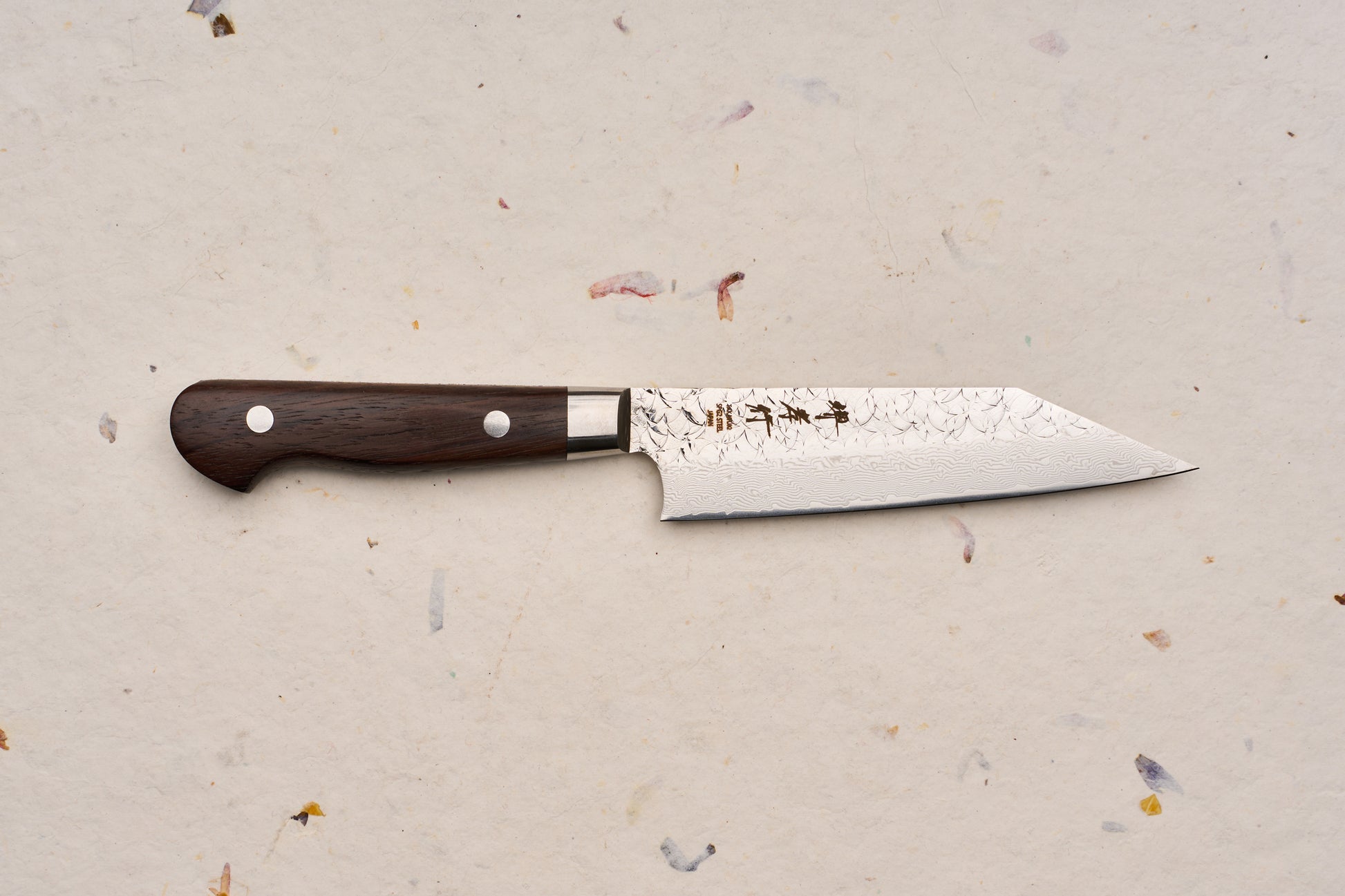 Sakai Takayuki SG2 Tsuchime Damascus Western Kengata Petty 120mm knife, featuring a slender, pointed Damascus-patterned blade and dark wooden handle with metal rivets, ideal for precise kitchen tasks.