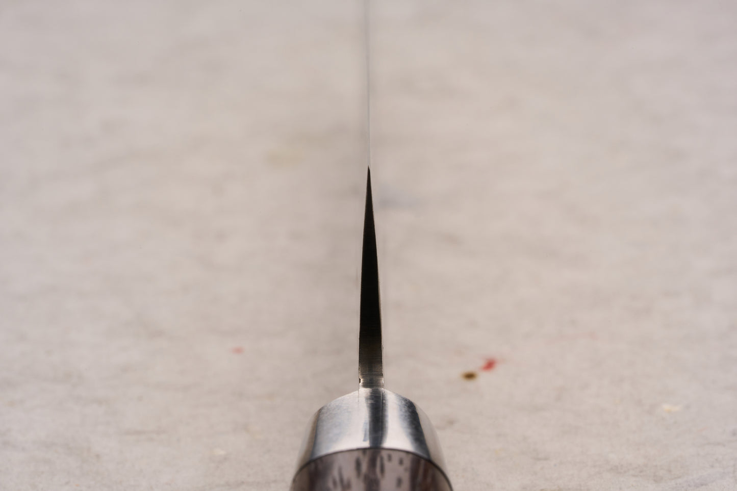 Sakai Takayuki SG2 Tsuchime Damascus Western Kengata Petty 120mm knife's blade and handle viewed head-on, showcasing its precise, slender design ideal for intricate cutting tasks.