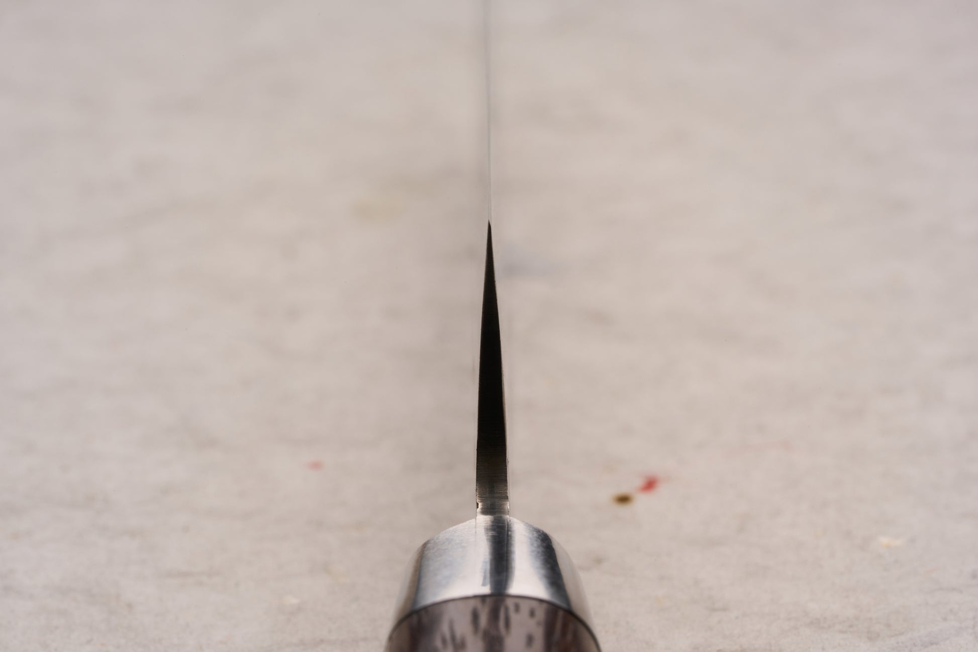 Sakai Takayuki SG2 Tsuchime Damascus Western Kengata Petty 120mm knife's blade and handle viewed head-on, showcasing its precise, slender design ideal for intricate cutting tasks.