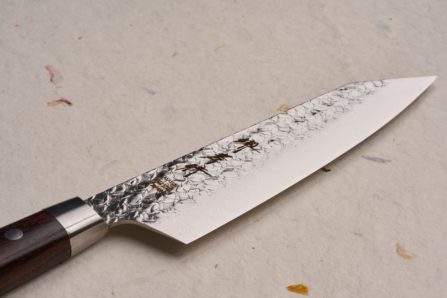 Sakai Takayuki SG2 Tsuchime Damascus Western Kengata Santoku 160mm: A high-end Japanese chef's knife featuring a hammered and Damascus-patterned blade with a traditional riveted wooden handle, ideal for versatile culinary tasks.