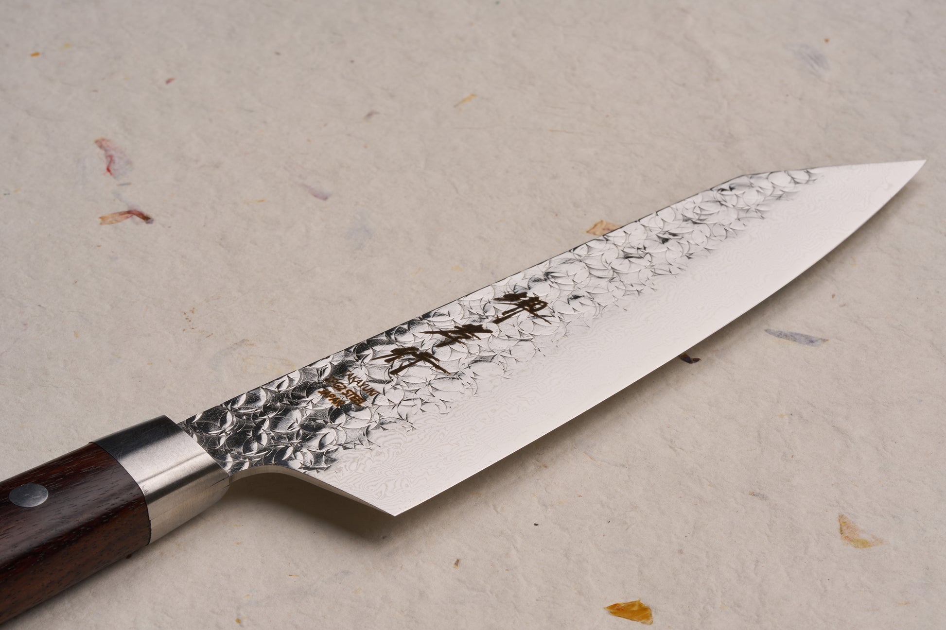 Sakai Takayuki SG2 Tsuchime Damascus Western Kengata Santoku 160mm: A high-end Japanese chef's knife featuring a hammered and Damascus-patterned blade with a traditional riveted wooden handle, ideal for versatile culinary tasks.