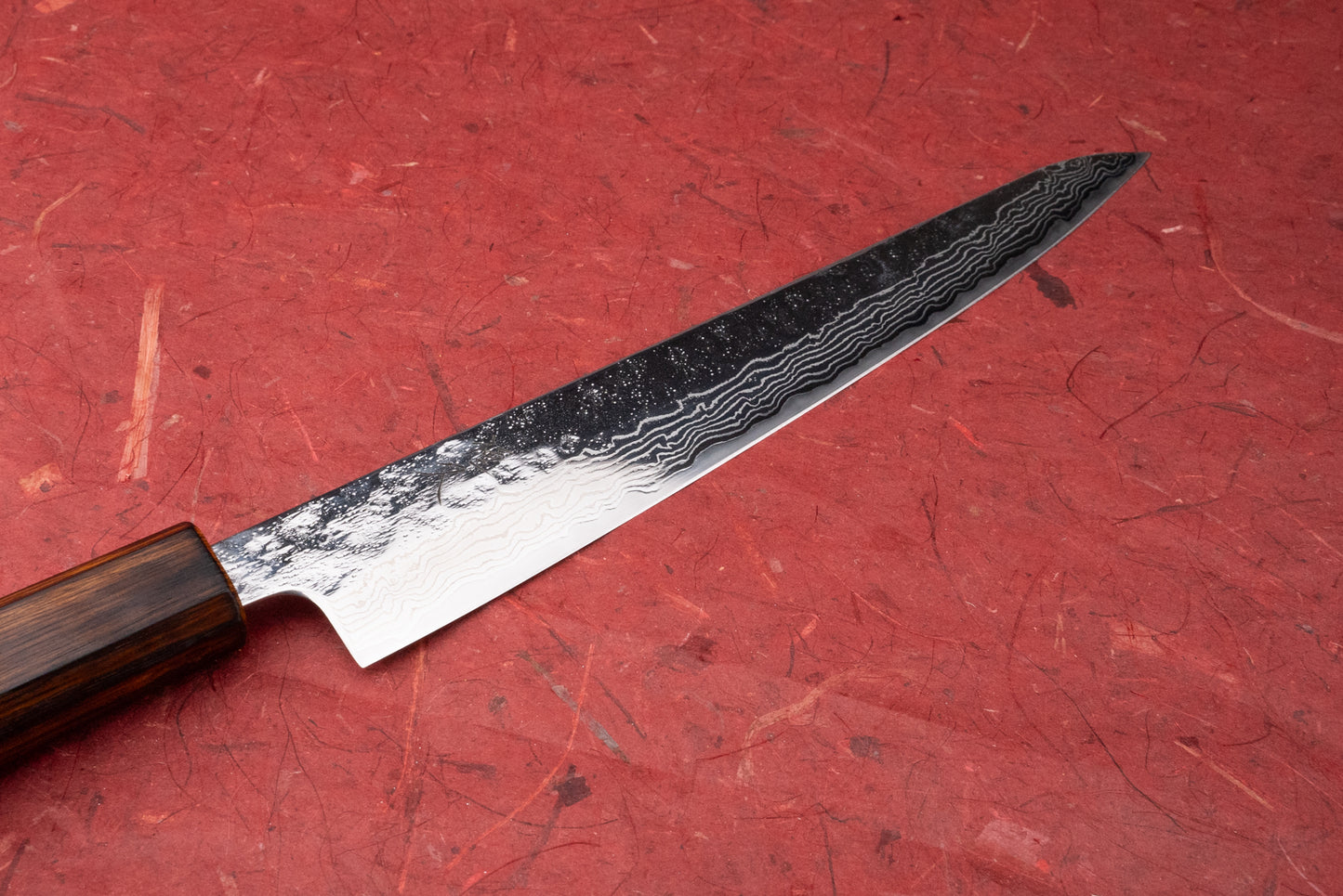 Tsunehisa 440C Sanjusan 参拾参 Tsuchime Migaki Damascus Sujihiki 240mm T-03312: a Japanese slicing knife with a damascus-patterned blade and dark wooden handle, ideal for precise meat and fish slicing.