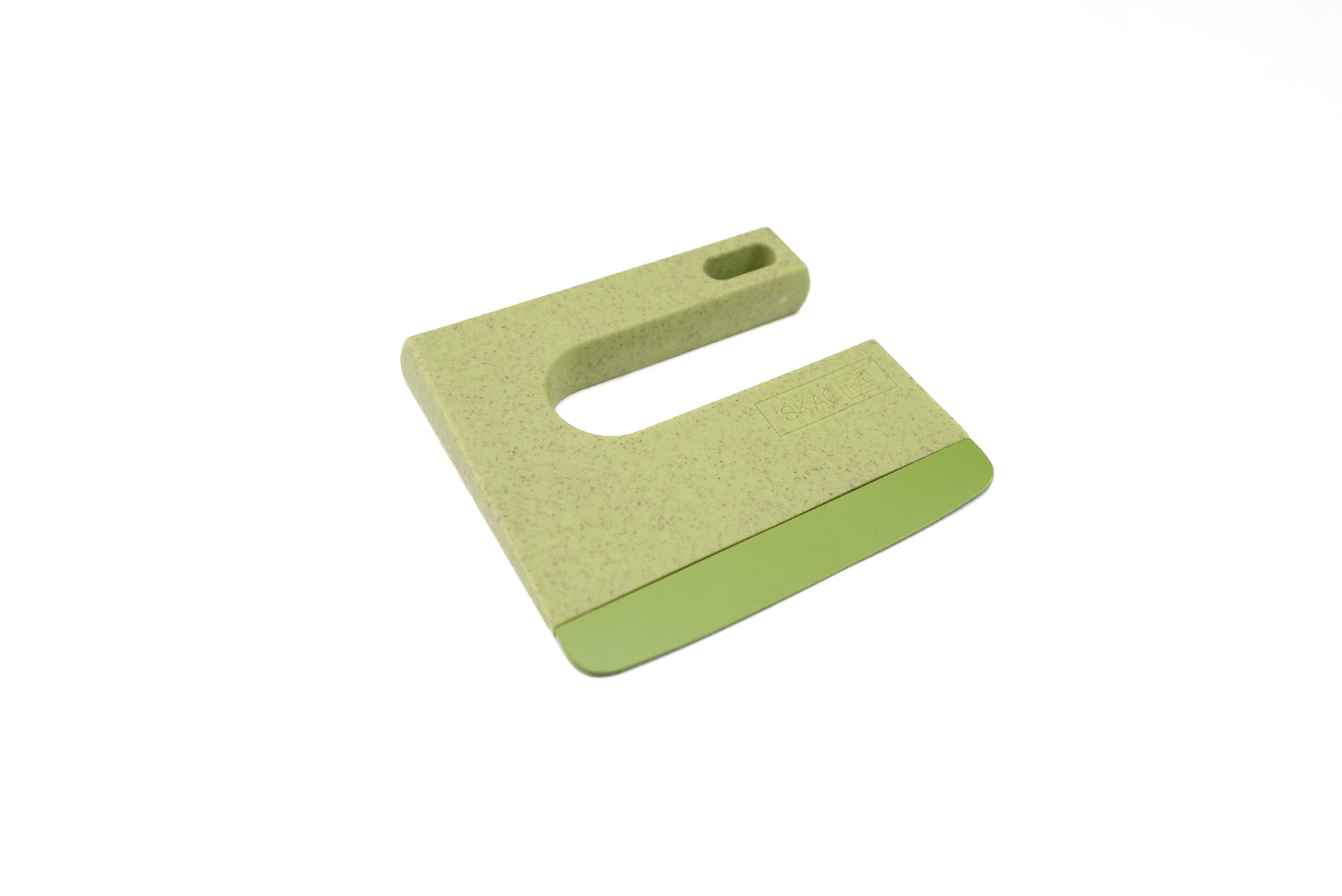 Skagfa Kid's Knife, a small U-shaped bench scraper, made of green speckled plastic, ideal for safely introducing children to cooking by cutting or scraping dough with ease.