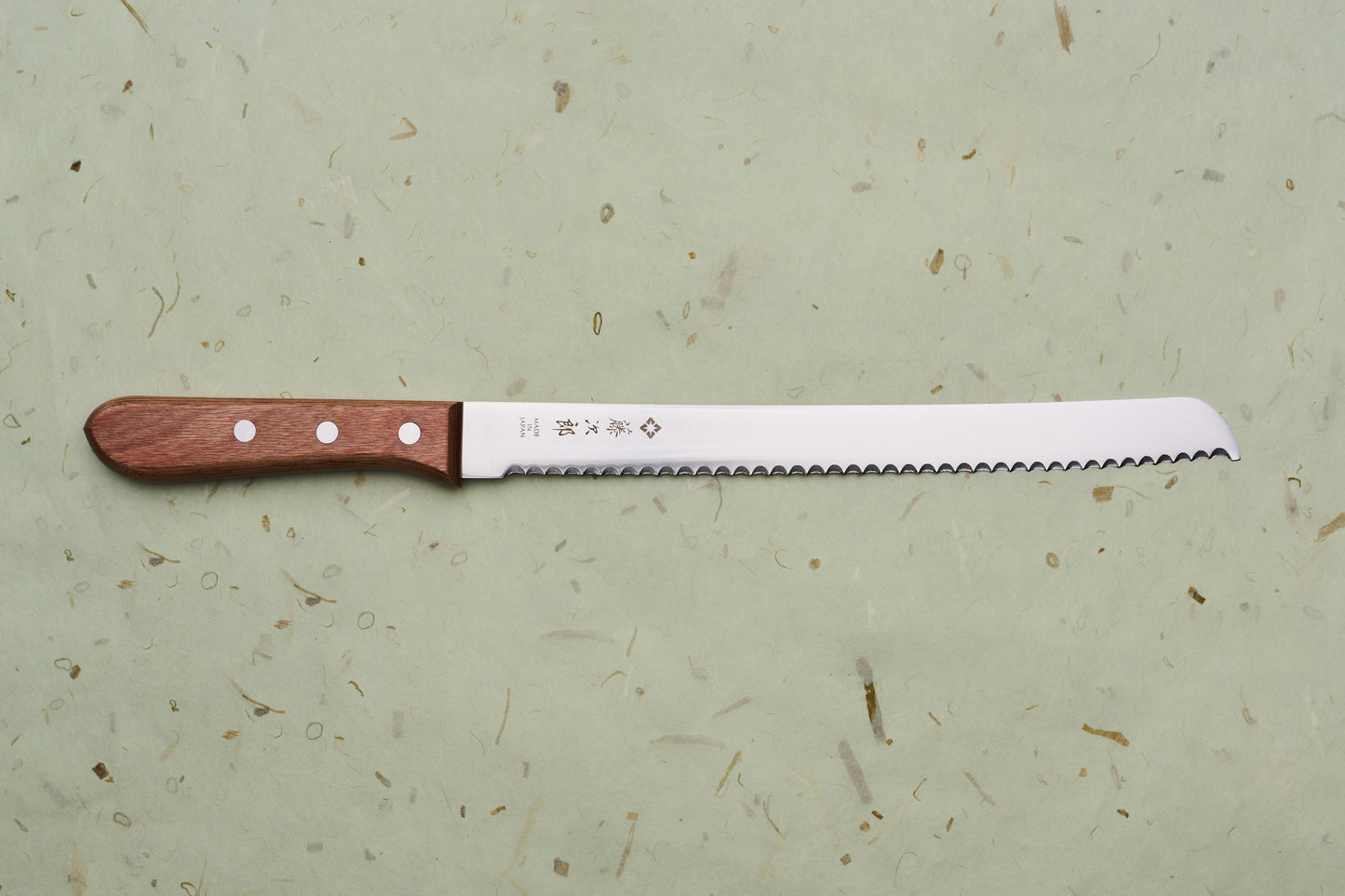 TOJIRO Bread Slicer 235mm F-737 with a serrated blade and wooden handle, crafted in Japan, ideal for effortlessly slicing hearty loaves.
