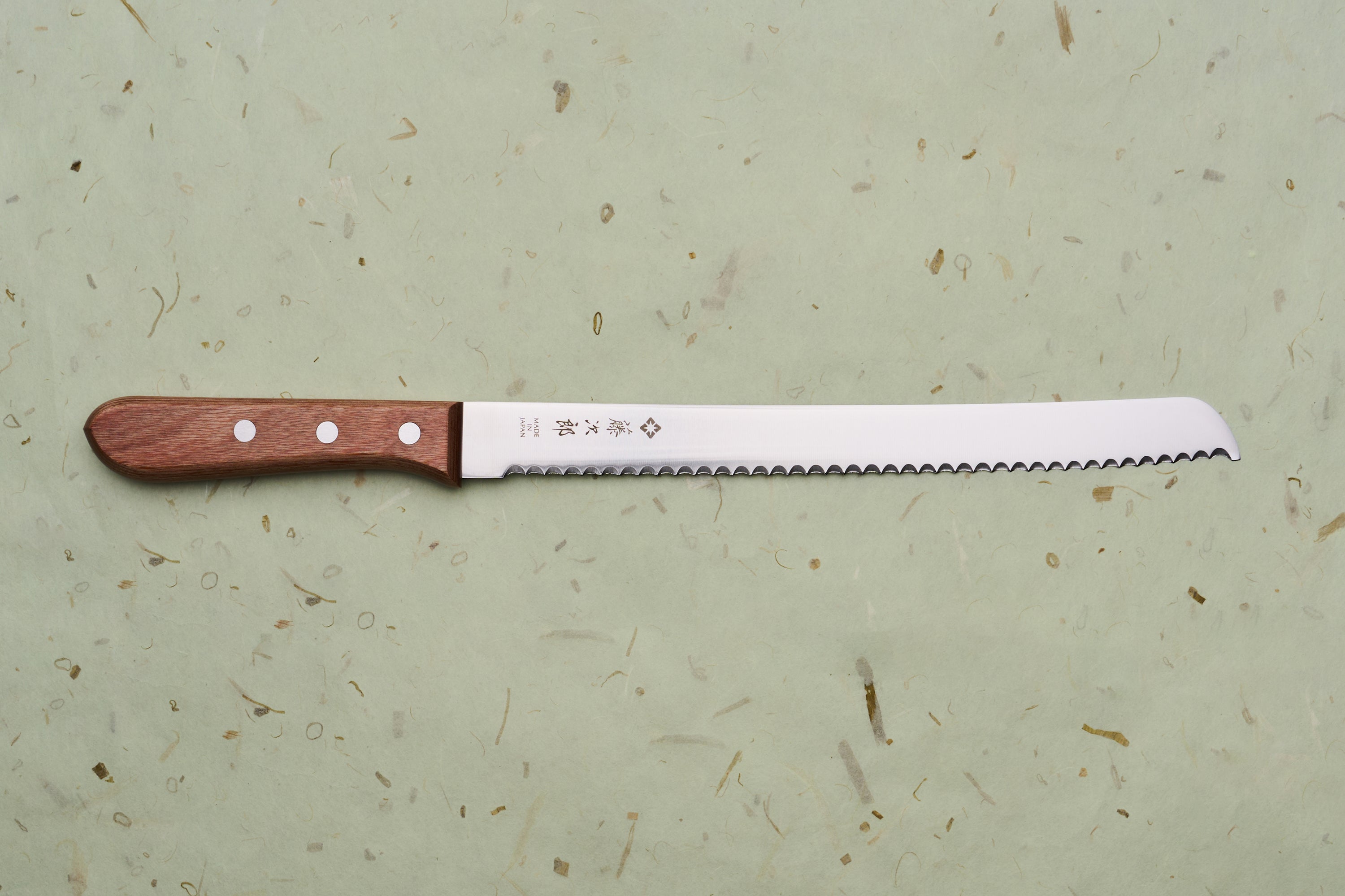 TOJIRO Bread Slicer 235mm F-737 with a serrated blade and wooden handle, crafted in Japan, ideal for effortlessly slicing hearty loaves.