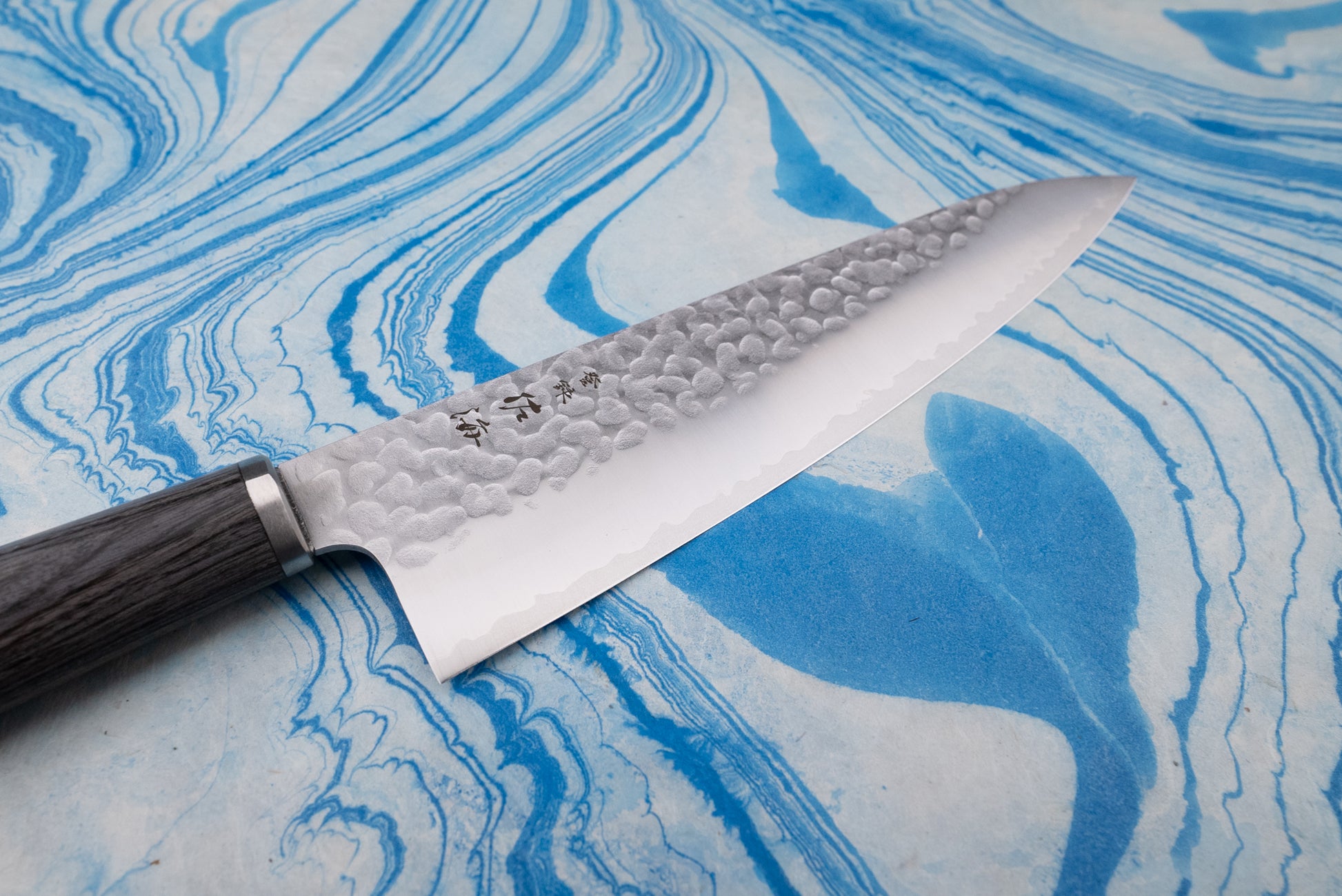 Touroku Sakai Gekka Gyuto 200mm knife with a hammered finish and wooden handle, showcasing a blend of Japanese and European design, perfect for versatile, precise kitchen use.