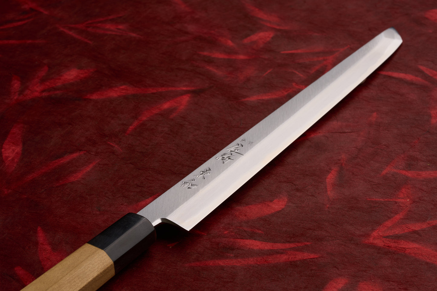 Touroku Sakai Tohwa Shirogami Sakimaru Takohiki 270mm, a traditional Japanese knife, features a single-bevel blade with engraved characters and an octagonal wooden handle, ideal for precision slicing.