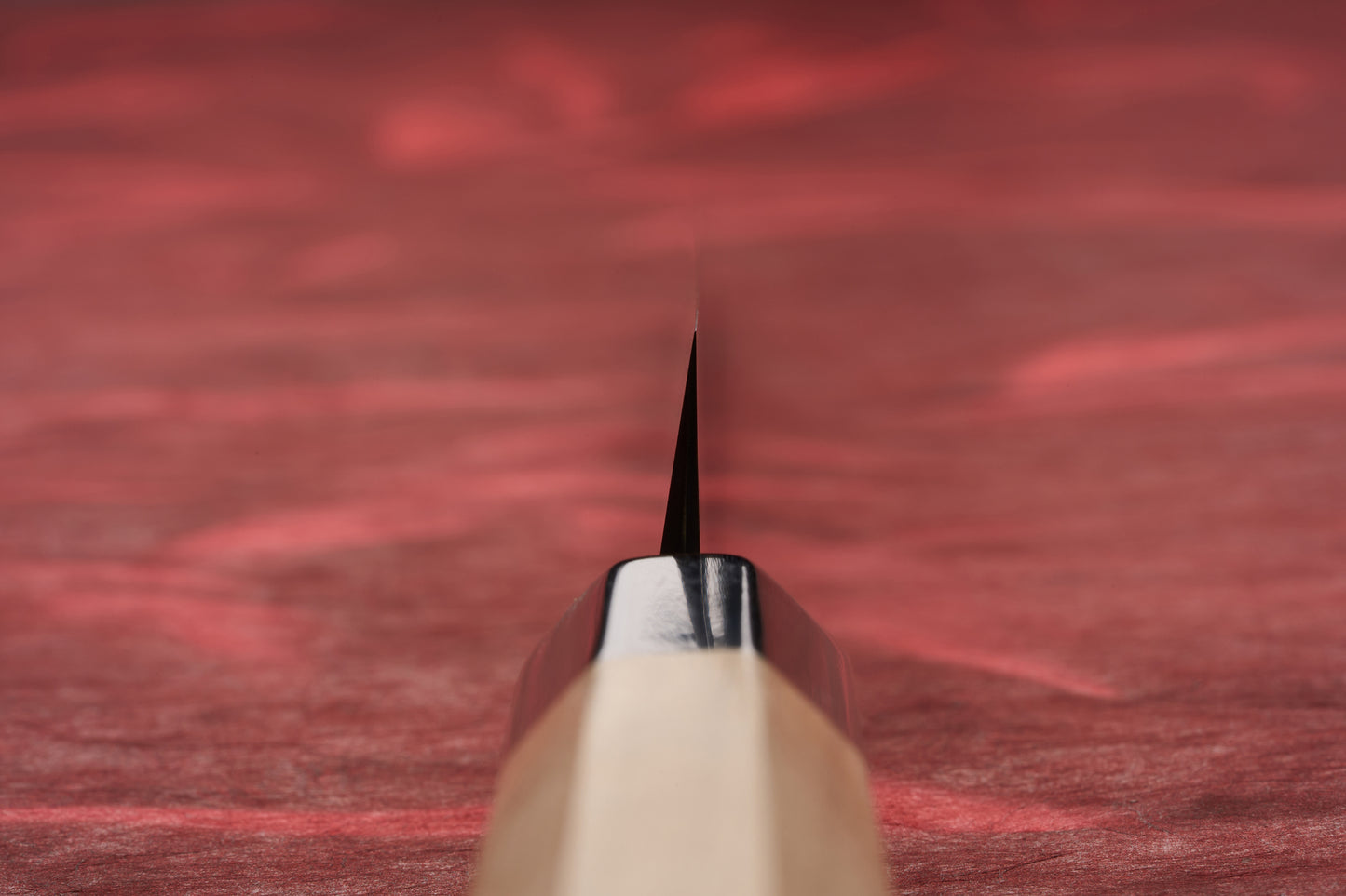 Touroku Sakai Tohwa Shirogami Sakimaru Takohiki 270mm displayed on a red surface, showcasing its sleek blade and handle craftsmanship, perfect for discerning chefs seeking superior Japanese steel artistry.
