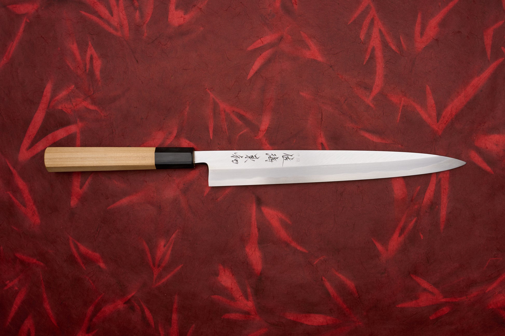 Touroku Sakai Shirogami Kasumi Yanagiba 240mm features a sleek, single-bevel blade and straight wooden handle. Perfect for sashimi slicing, it embodies precision and elegance, ideal for Japanese kitchen enthusiasts.