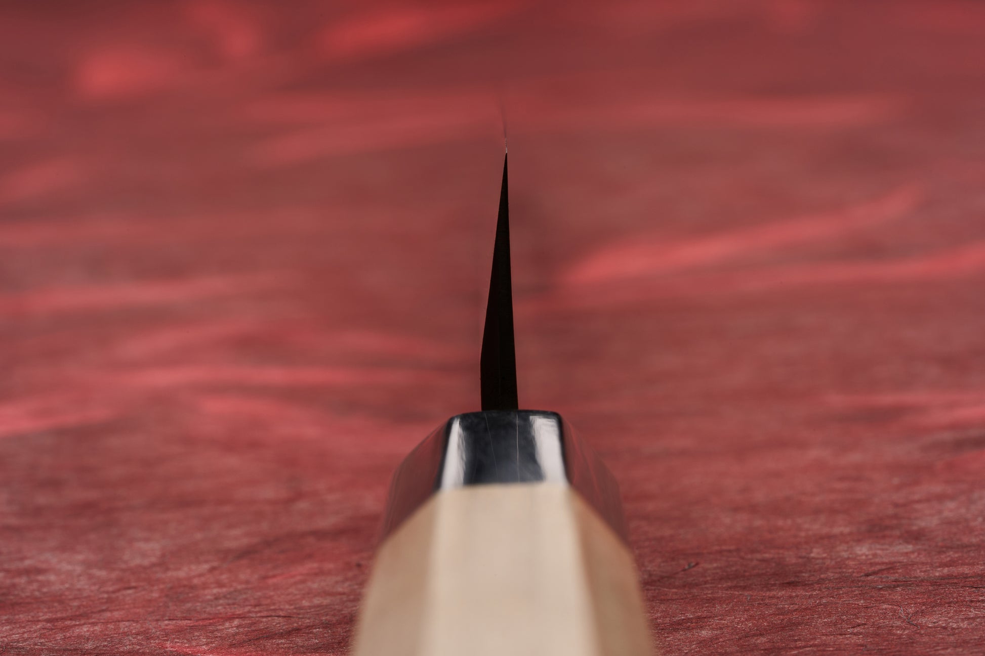 Touroku Sakai Tohwa Shirogami Yanagiba 240mm, seen edge-on, highlights its sleek, single-bevel blade and octagonal handle, epitomizing precision for slicing sashimi, as showcased by Knifewear's curated Japanese steel selection.