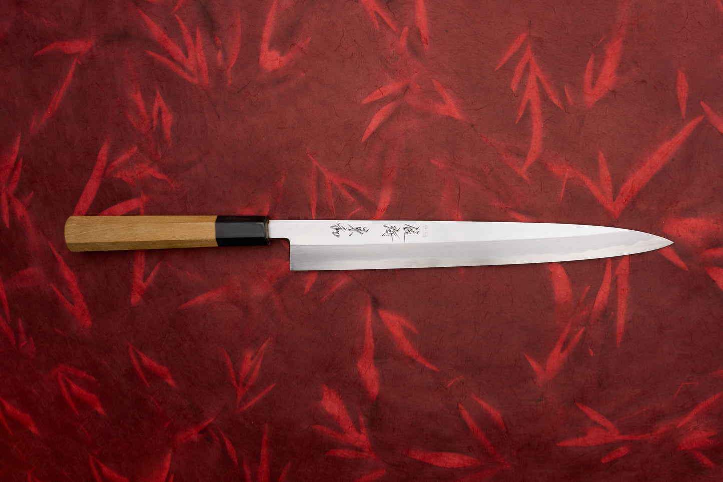 Touroku Sakai Tohwa Shirogami Yanagiba 270mm knife features a slender, single-bevel stainless-steel blade with Japanese engravings, black ferrule, and octagonal wooden handle, perfect for slicing sashimi and carving meats.