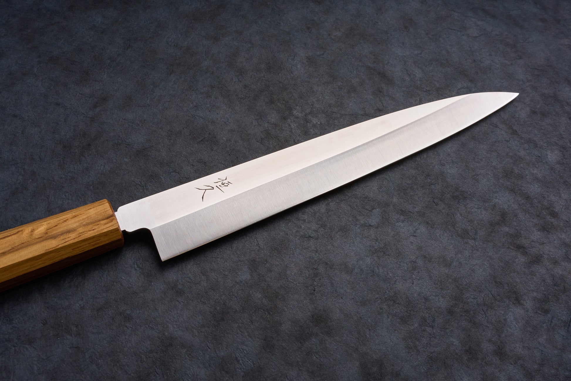 Tsunehisa AUS8 Sanjukyu 参拾玖 Migaki Yanagiba 240mm T-03918, a single-bevel Japanese kitchen knife, with an octagonal wooden handle, displayed on a slate surface.
