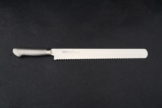 Brieto Pro Bread Knife 330mm M1150, featuring a long, serrated stainless-steel blade and a hammered-metal handle, displayed flat on a dark surface, epitomizing the precision and craftsmanship of Japanese kitchen knives.